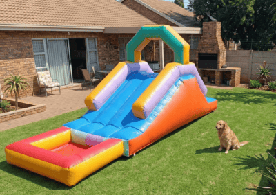 Inflatable water slide in a backyard with a dog nearby, perfect for children's outdoor fun.