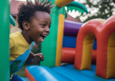 Happy child enjoying fun on inflatable bounce house at Giggle Party.